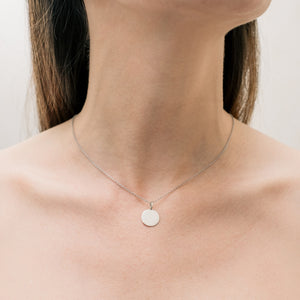 Minimalist silver necklace with circular pendant in silver